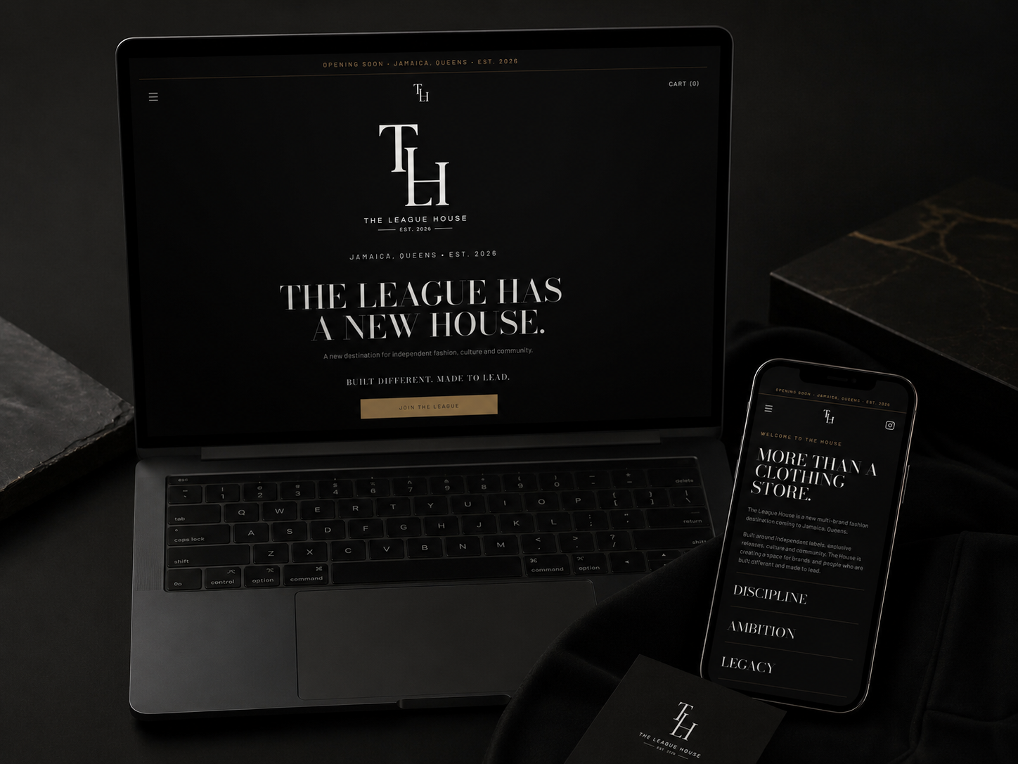 The League House website shown on a laptop and phone with a dark, gold-accented luxury streetwear layout
